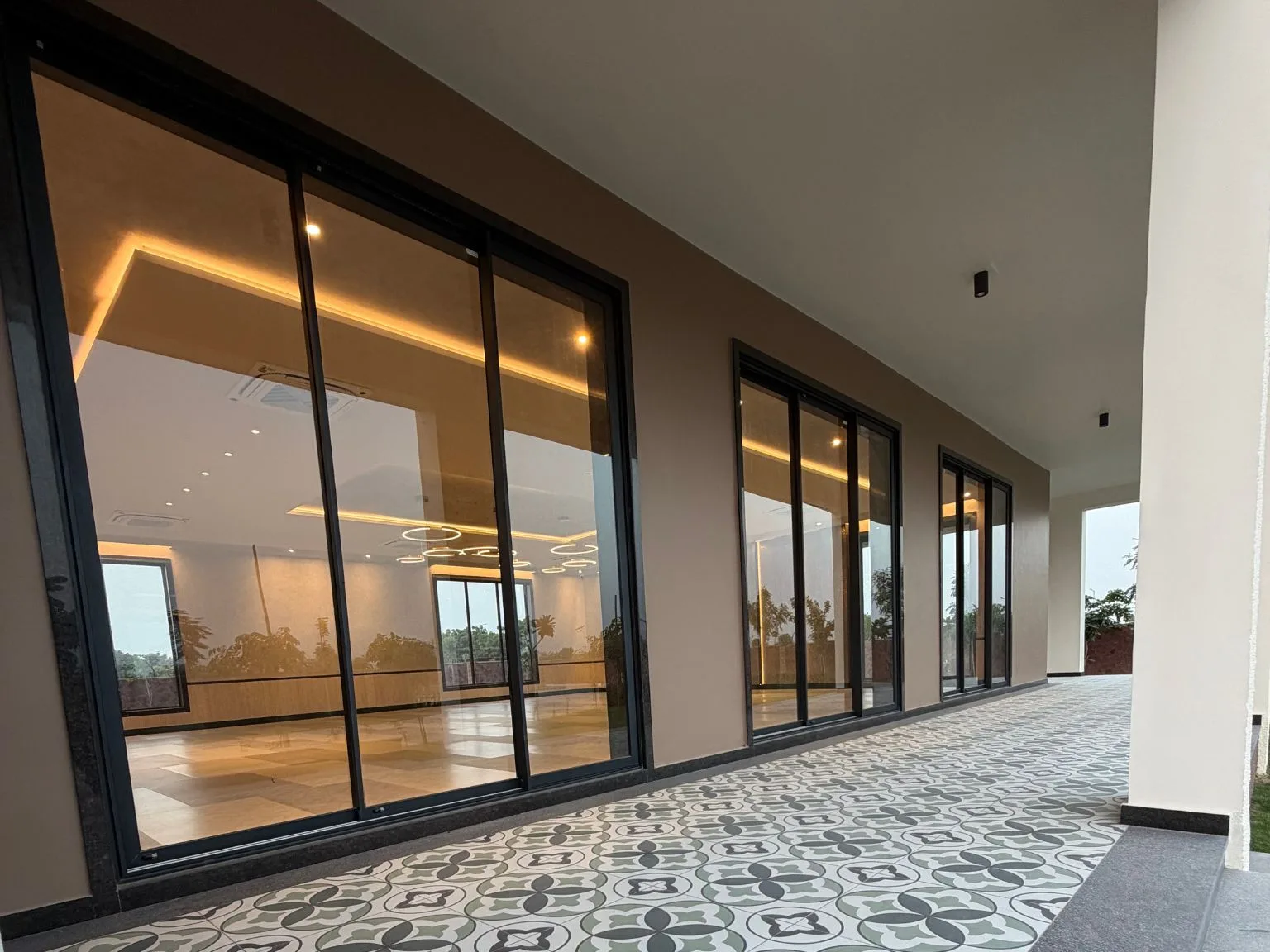 BAARI aluminium sliding doors and windows with slim black frames along a modern building exterior